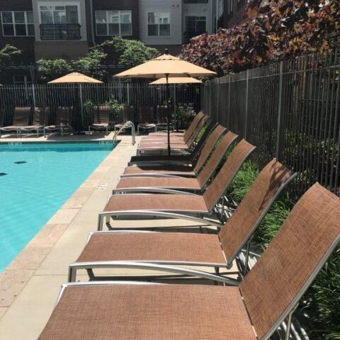 Photo Of Patio Chairs On A Cement Patio With A Pool