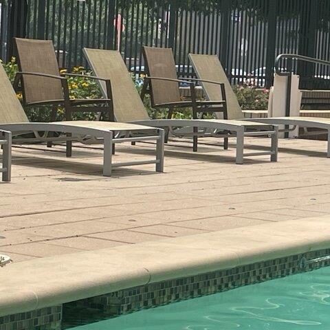 Photo Of Patio Chairs On A Cement Patio With A Pool