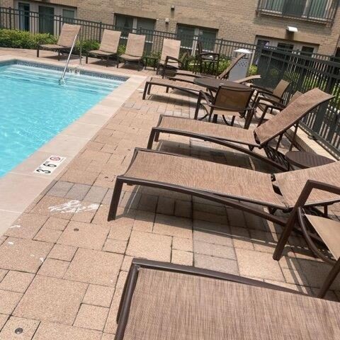 Photo Of Patio Chairs On A Cement Patio With A Pool